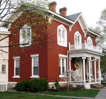Оформление фасада дома красного цвета в эклектичном стиле