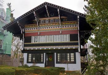 Дизайн фасада частного дома пестрого цвета в шале стиле