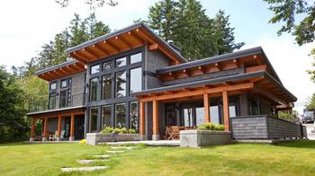 Пример красивой отделки фасада дома серого цвета в современном стиле